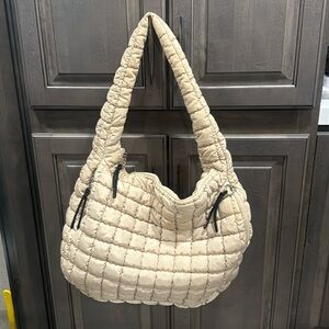 Cream colored free people quilted carry all bag.